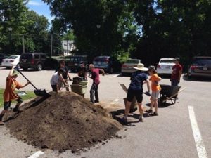 Soil delivery, 2015; volunteers help to relocate and fill raised beds.